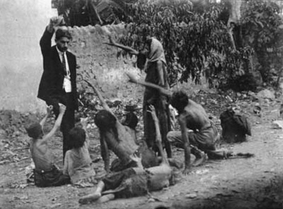 Turkish official teasing starving Armenian children by showing bread, 1915.  Collection of St. Lazar Mkhitarian Congregation.