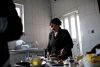 Katrina, wife of Berkho Odeesho, Dawudiyah’s mayor, preparing food in her kitchen. Mr. Odeesho hopes to uproot his family, as hard as it may be, for a new future in a distant place called Chicago.  Credit: Adam Ferguson for The New York Times